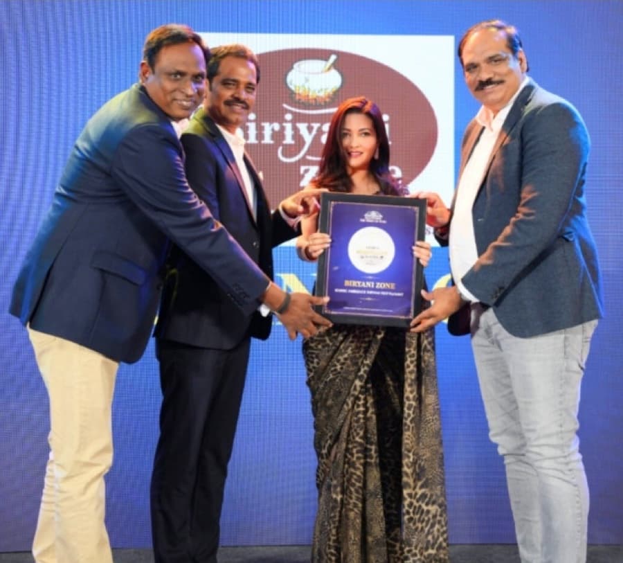 Biriyani Zone receiving the Iconic Ambience Biryani Restaurant award from Times Hospitality